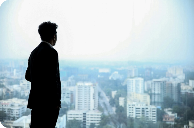 image of a man standing and looking over a city