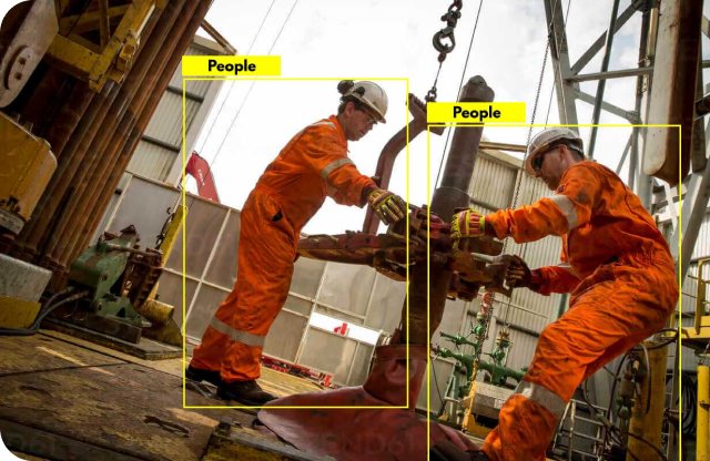 image of two factory workers identified with AI
